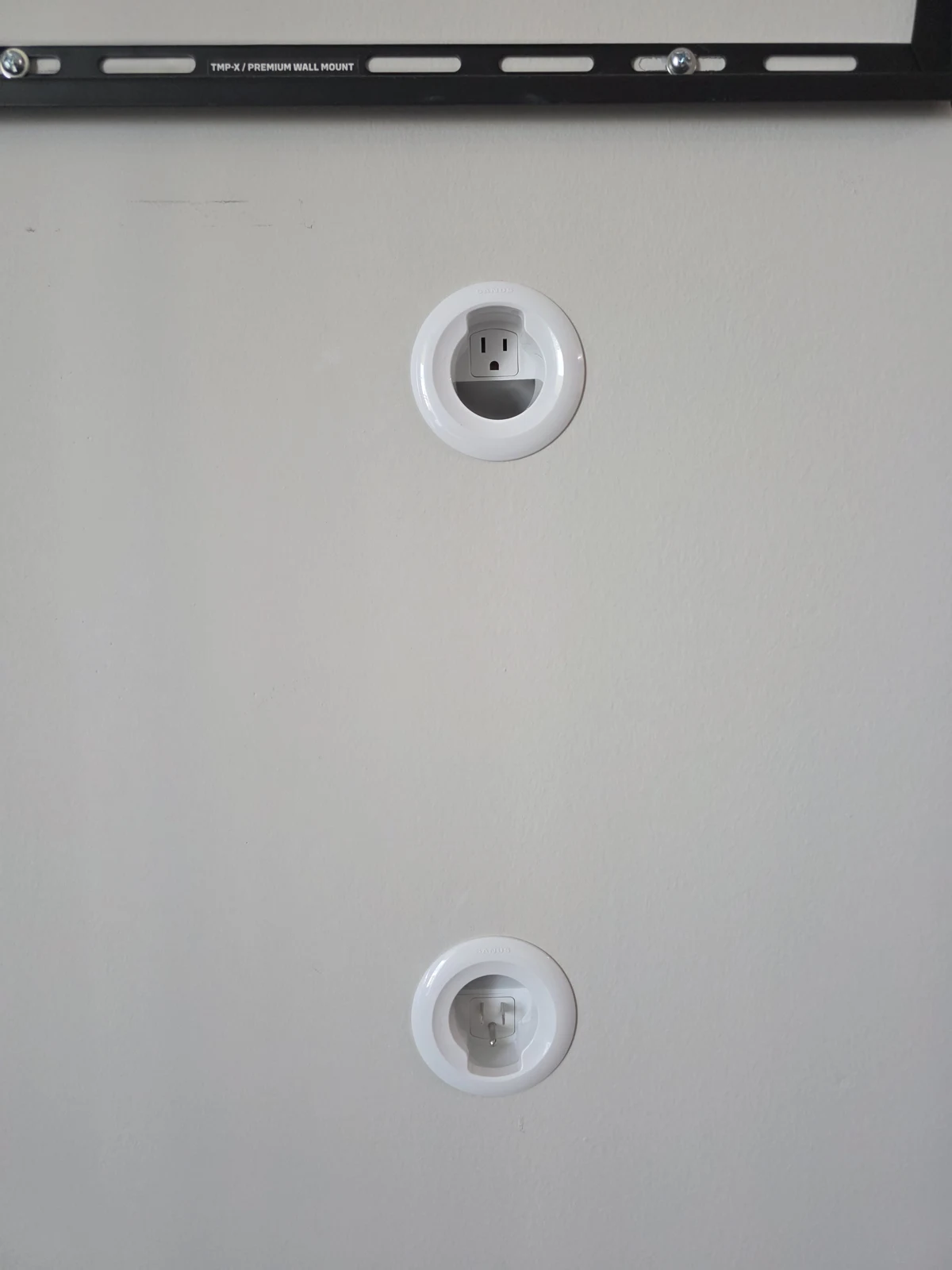 Recessed cable and power connection points installed beneath a TV mounting bracket