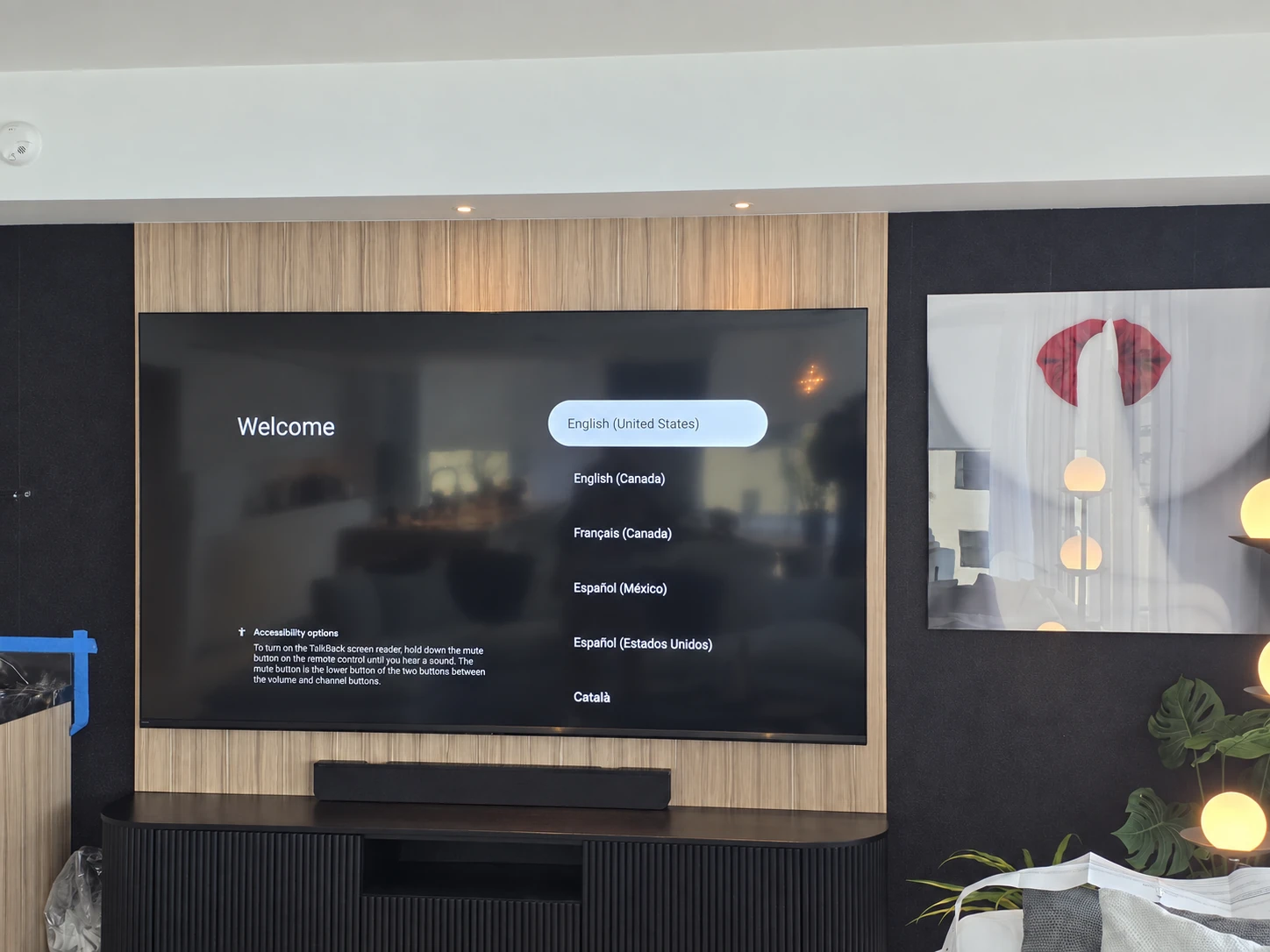 TV mounted on an existing wood feature wall with a soundbar below